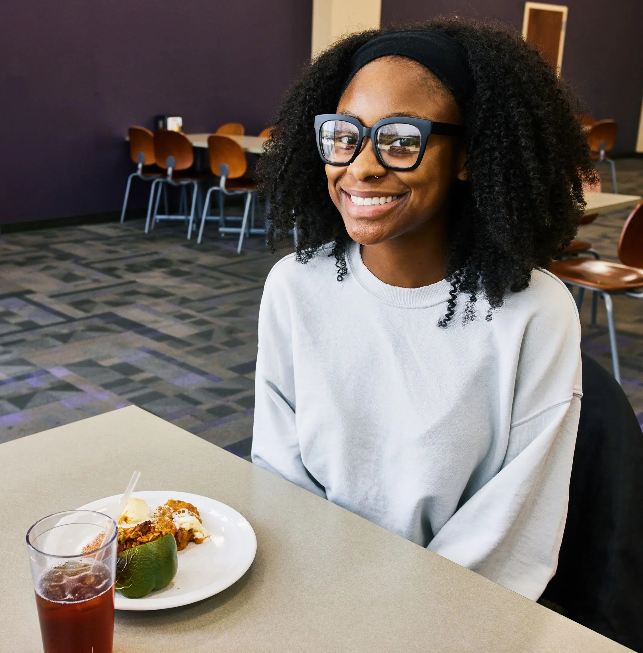 Student smiling with food at camelot court