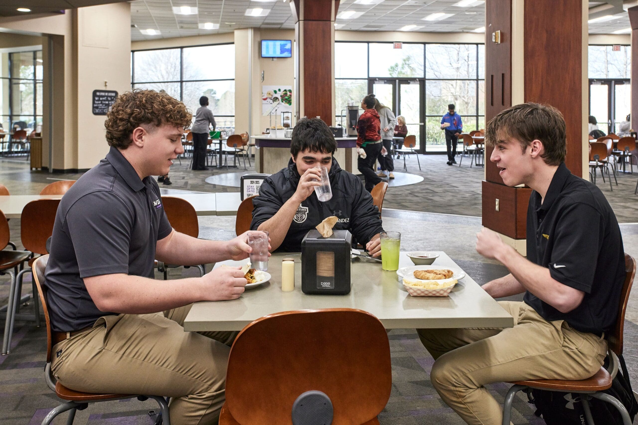 students conversing while eating at dining hall